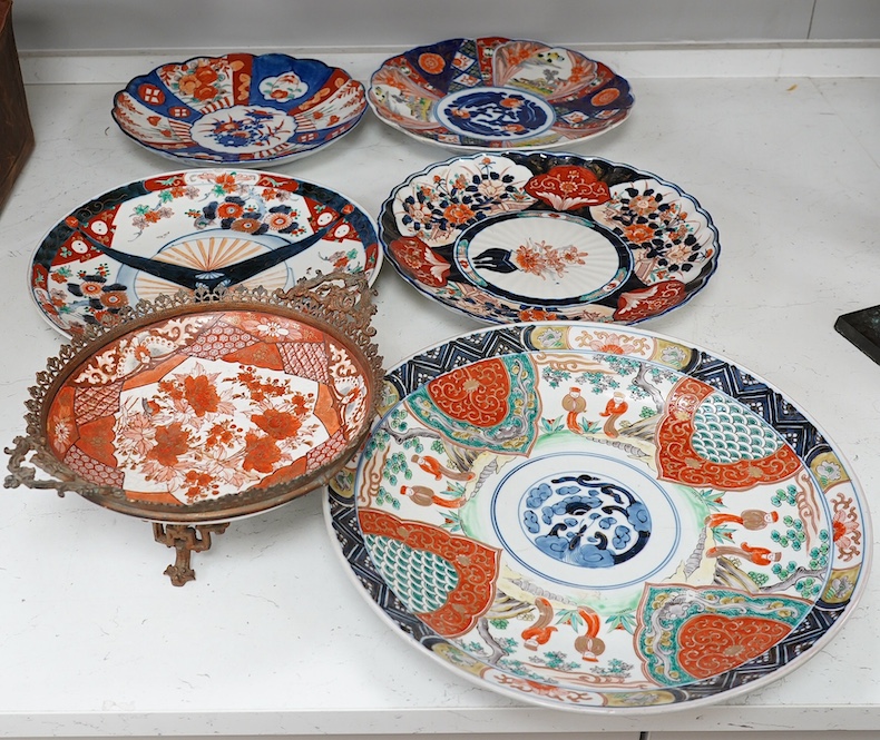 Five Japanese Imari dishes and a Kutani gilt metal mounted bowl, Meiji period, largest 35cm. Condition - poor to fair